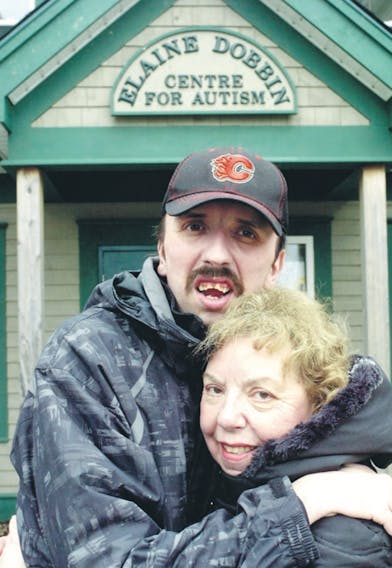 Joyce Churchill, former head of the Autism Society of Newfoundland and Labrador, stands with her son Stephen outside the Elaine Dobbin Centre for
Autism. Stephen was diagnosed with autism when he was five.