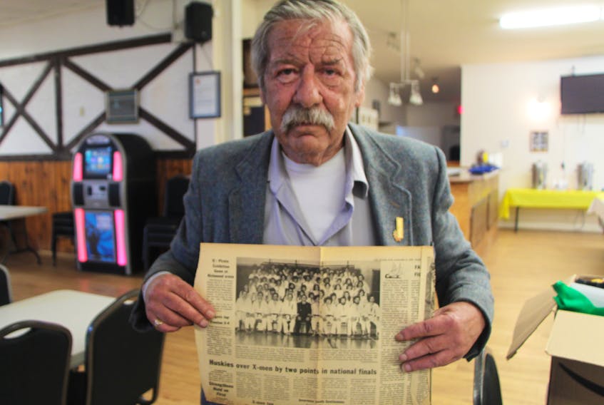 Instructor Wayne Reynolds holds up an old newspaper photo of Port Hawkesbury Judo Club members, following a celebration of the club’s golden anniversary June 22.