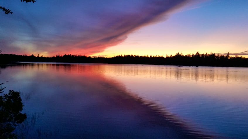 Clear skies don't always result in the best sunsets. Some cloud cover can add interest and bounce the light around from the setting sun.  Garnet Uhlman captured this stunning sunset scene at Barnes Lake in Digby County N.S. He says: the overcast sky rolled east with clear sky from the west …a very defined separation of the two sides.