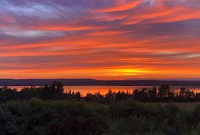 Sunset photos can be a little bit like rainbows- somewhat unique to the observer’s eye. 
This is what Monday evening’s offerings looked like in Point Edward, on Cape Breton Island.
Peter John Hill captured this incredible display of crimsons in the western sky.  Red sky at night…