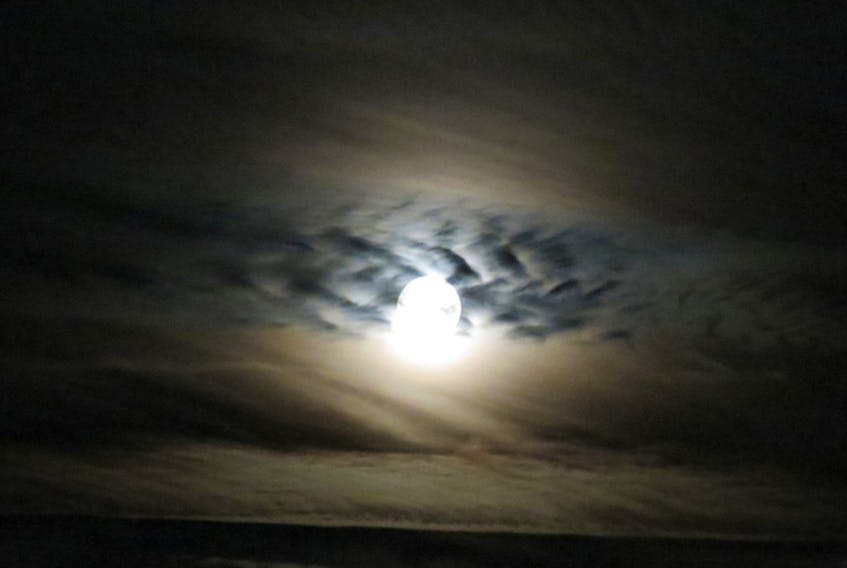 If not for the stifling heat, Tuesday evening’s full moon could have been mistaken for a Halloween moon. Pat Hollingshead snapped this eerie photo of a spooky sky over Glen Haven, along St. Margarets Bay NS just after 10 p.m. The braid of mid-level cloud created a lovely backdrop for the Full Thunder or Moon.