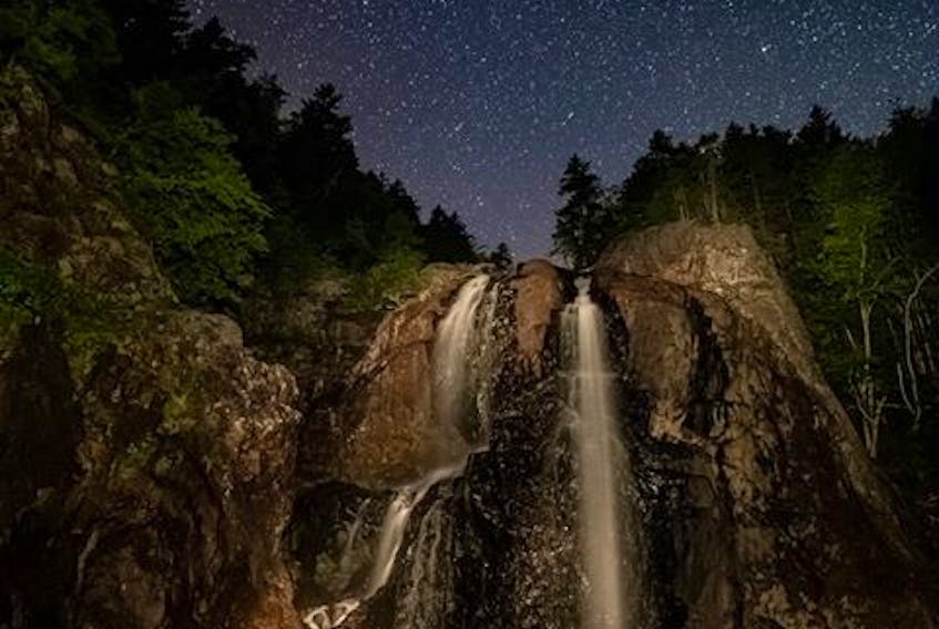While you’re sleeping…Barry Burgess hikes. 
Barry says: “third time lucky. On my third night-hike to East Moose River NS, the sky was still clear by the time I reached the main fall. This fall is the tallest in mainland Nova Scotia at 100 or more feet”. 
Barry snapped this amazing photo last Friday night. Thank you for taking us along on your journey Barry.  Happy Canada Day!