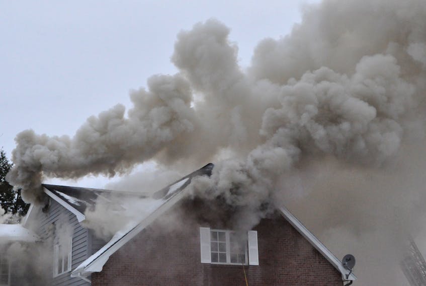 Smoke poured out of the house as the fire worked its way through the building.