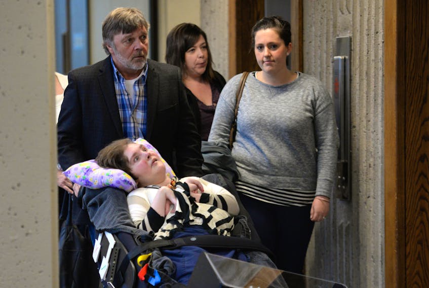 Byron Huntley wheels his daughter Joellan Huntley, 33, into Nova Scotia Supreme Court in 2015 (FILE).