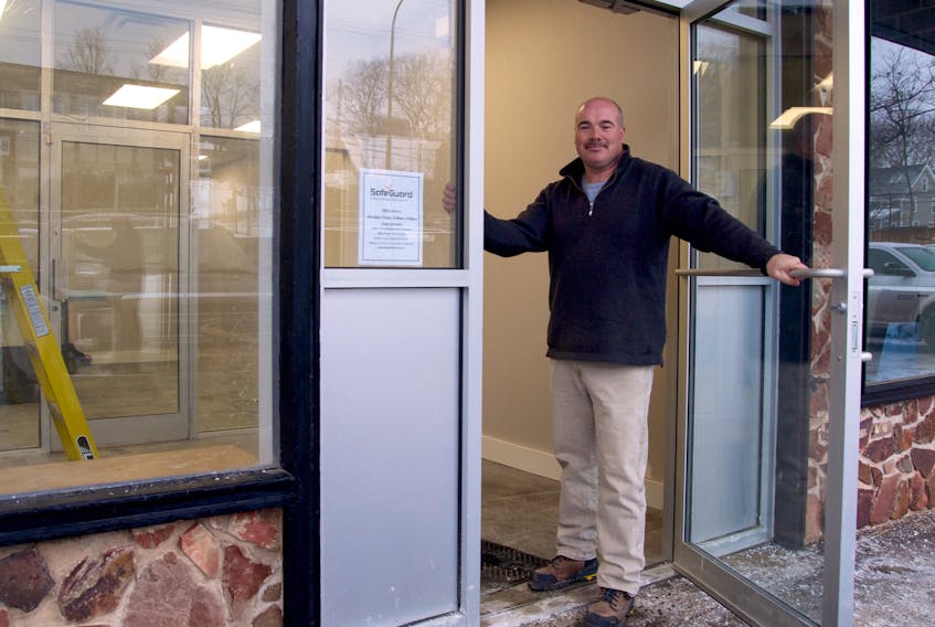 Paul Dixon stands at the entrance to SafeGuard’s new office space inside the Cornwallis Inn. The entrance was formerly used for the building’s liquor store.