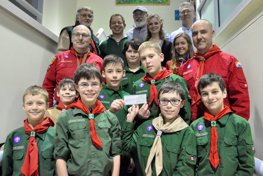 Members of the Wolfville Scouts Club stands below the Valley Regional's Physicians Philanthropic Fund inside the Valley Regional Hospital, which the scouts toured after receiving a nearly $7,600 donation from the group.