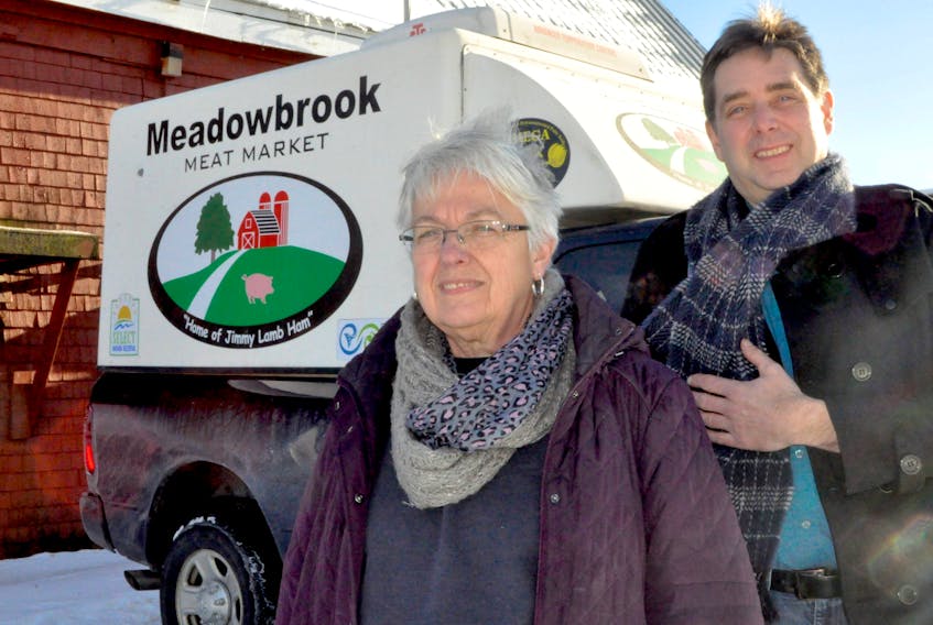 Meadowbrook Meat Market owner Margie Lamb stands with operations manager Michael Trombley with their delivery truck, which will begin delivering groceries to customers Jan. 31.