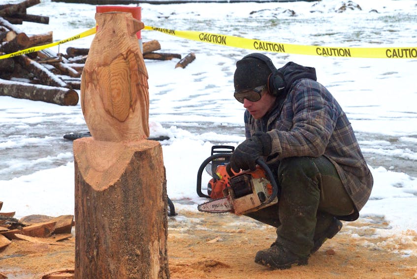 Justin Dagley sizes up the wing on a cardinal he started carving at the Berwick Winter Carnival Feb. 10.