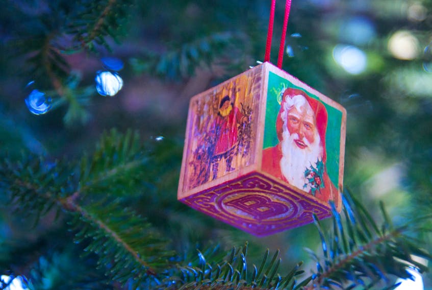 A traditional style letter block Santa ornament hangs on the Christmas tree at the DeWolf house.