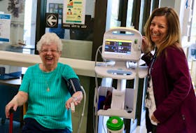 Frances Allen helps test out the mobile vital signs monitor and stand that the Upper Vaughan Hospital Auxiliary purchased for Unit 500 at the Hants Community Hospital. Pictured showing Allen and her fellow auxiliary members how the monitor works is clinical leader Michelle Maynard.