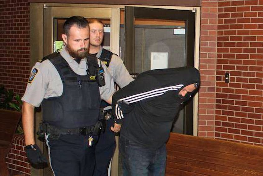 Sheriff's deputies lead Darrin Phillip Rouse from Kentville Supreme Court after being sentenced to five years in prison for having sex with a 13-year-old girl when he was in his 40s.