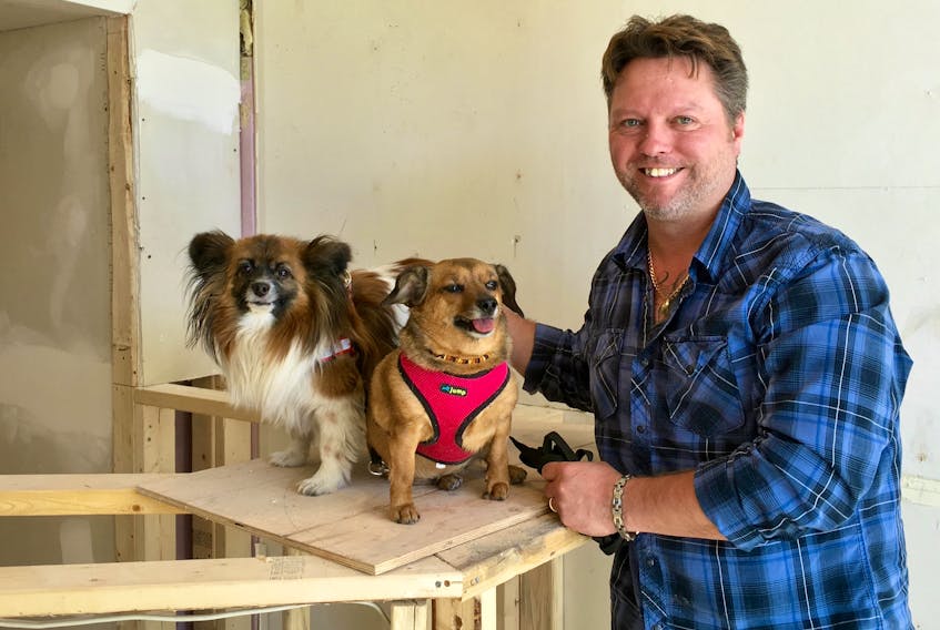 The Barking Bean co-owner Glenn Deering with two of his rescue dogs Shay left and Timo. The location is still under construction, but they’re hoping to open their doors in early June.