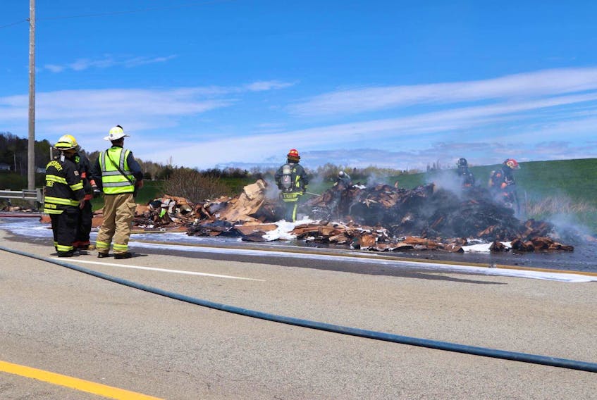 Volunteer firefighters extinguish a stubborn cardboard fire along Highway 101. Firefighters from Hantsport, Windsor, Brooklyn, Wolfville and more assisted with the effort. - ADRIAN JOHNSTONE
