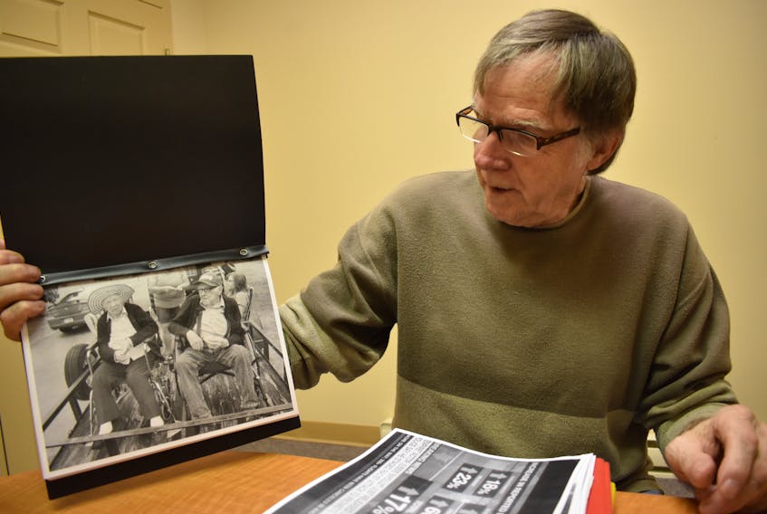 Clayton Dauphinee, originally from Nictaux, holds a photo of his parents, Hazel and Frank Dauphinee.