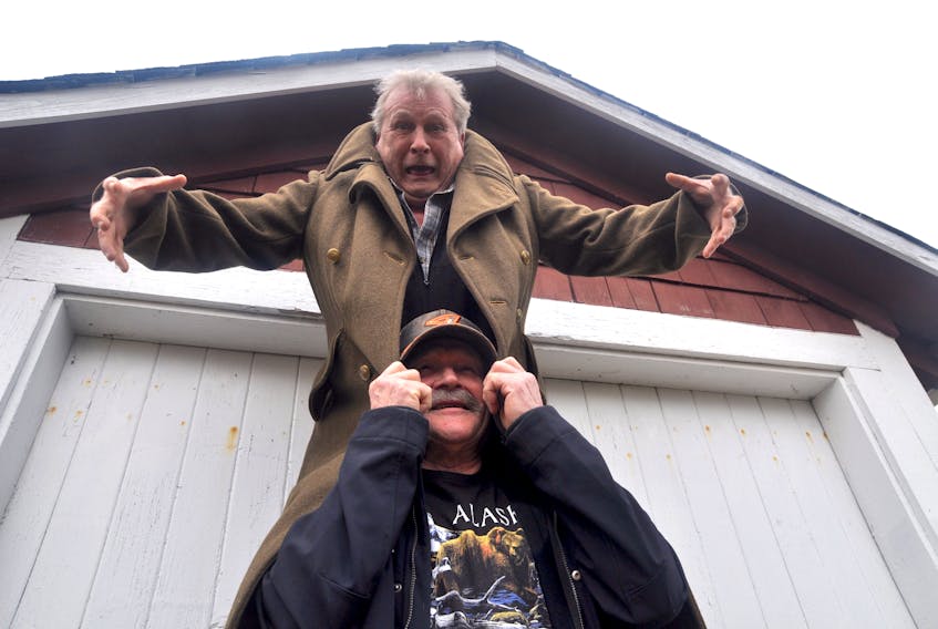 Dickie Taylor and Tommy Gates laugh as they recreate the iconic Parker Road Phantom pose that saw Billy Gates perched on Tommy’s shoulders as he’d run across the road.
