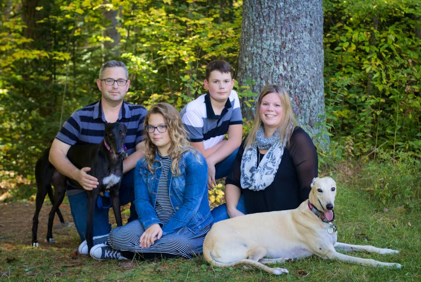 Kidney disease survivor Penny Hughes of Kingston is pictured with her husband and children – Owen Hughes, Caitlyn Hughes and Ian Hughes – and the family dogs.