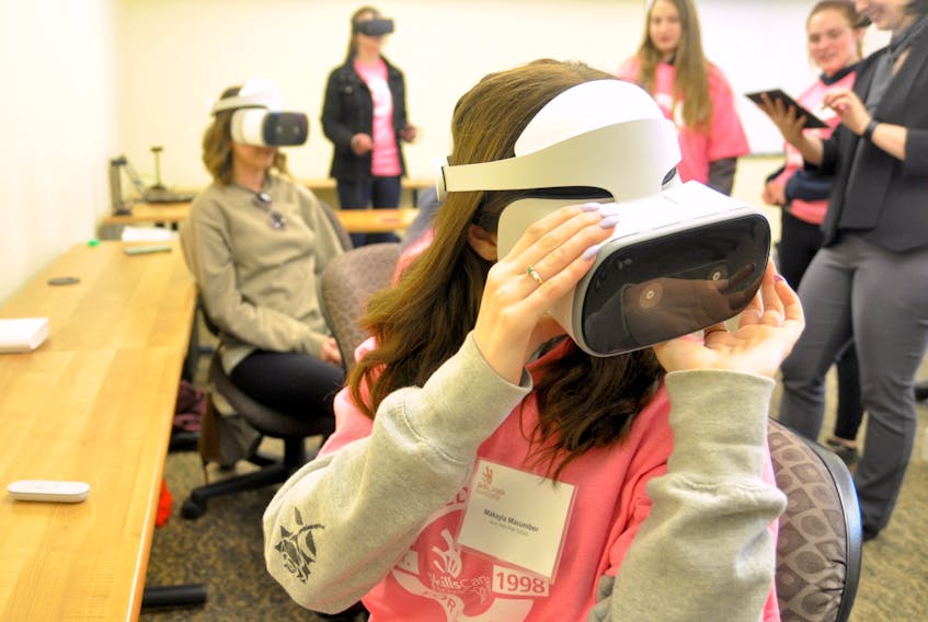 Makayla Macumber tries virtual reality on for size at the Skilled Futures for Women in Technology event April 26 at Acadia University,