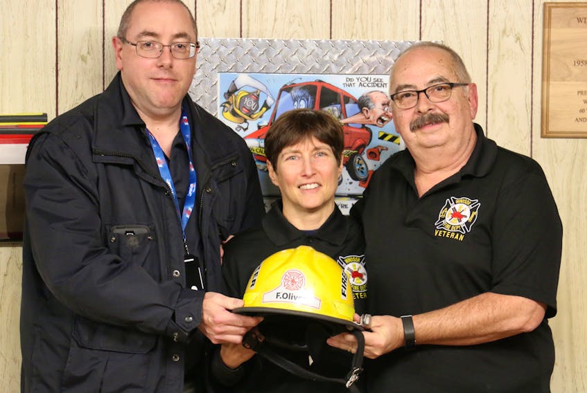 Deputy fire chief Jamie Juteau, left, and Windsor Fire Department Veterans Association president Bob DeMont, congratulate retired volunteer firefighter Frances Oliver on becoming the first woman to join the veterans group. She served 16 years with Windsor Fire.