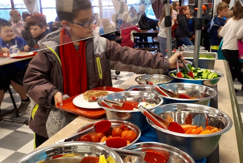 Berwick and District School student Oliver Whelan samples from the Berwick School Food Project’s salad bar and healthy lunch menu during lunch.