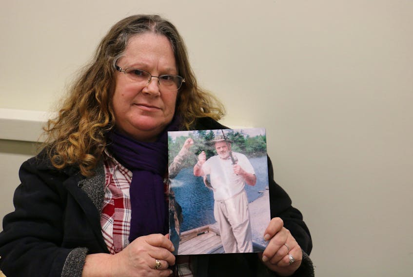 Vivian Wells holds onto a photo of her brother, Tim Wells, who has been missing since May 2018. She's still grappling with his disappearance as the siblings were quite close.