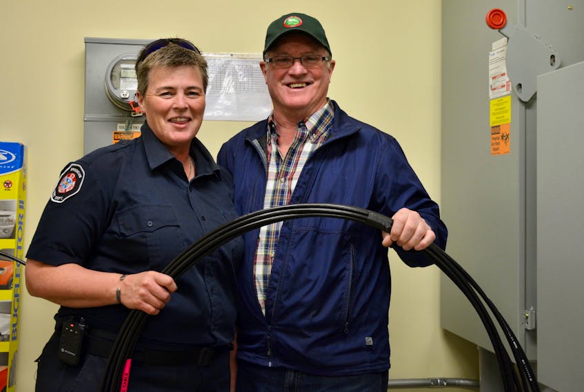 Tracy Keddy, a volunteer with the Brooklyn Fire Department, and West Hants Coun. David Keith stand inside the electrical room, where fibre cable is ready for installation.