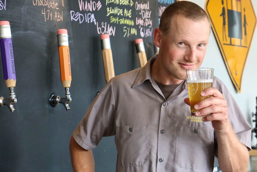 Leigh Davison smells a freshly poured glass of Skratch Plaskett before taking his first sip. Davison began volunteering with Schoolhouse Brewery in its early days and worked his way up to being the head brewmaster.
