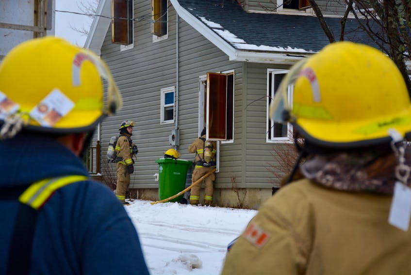Firefighters work to extinguish a structure fire in Three Mile Plains on Jan. 1.