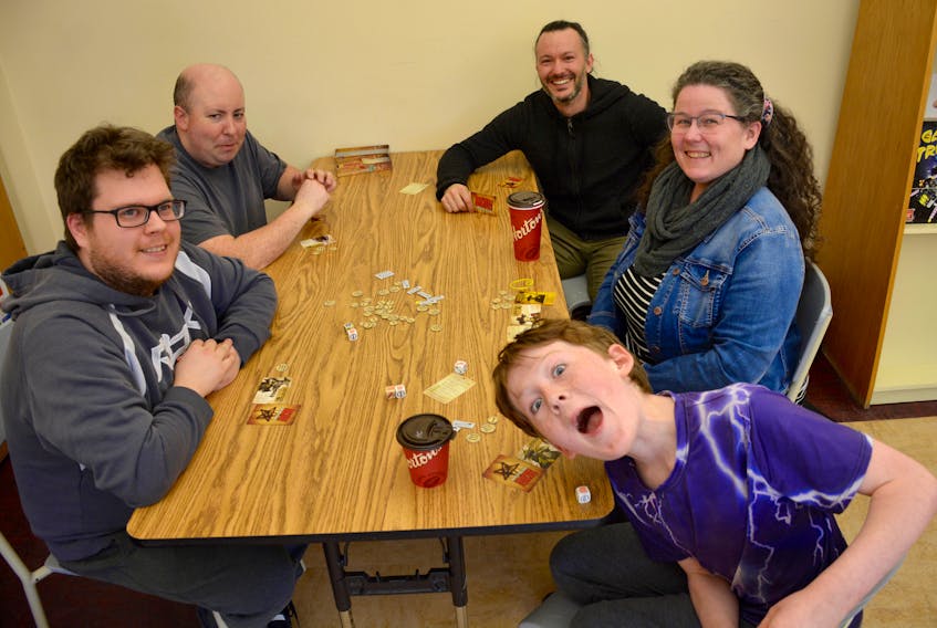 Clockwise, Stephen Wolfe, Colin Kennedy, Tony Gallant, Allison Friars and Jack Friars, 11, enjoy a game while attending Valley Game Night at the Windsor Regional Library on April 9, 2018.
