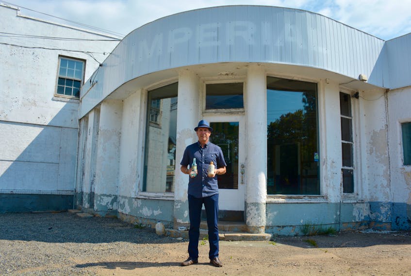 Michael Oxner stands in front of the former Stephens and Yeaton garage on Water Street in Windsor. The old business will soon be retrofitted into the James Roué Beverage Company, featuring a tasting bar, retail location and small restaurant.