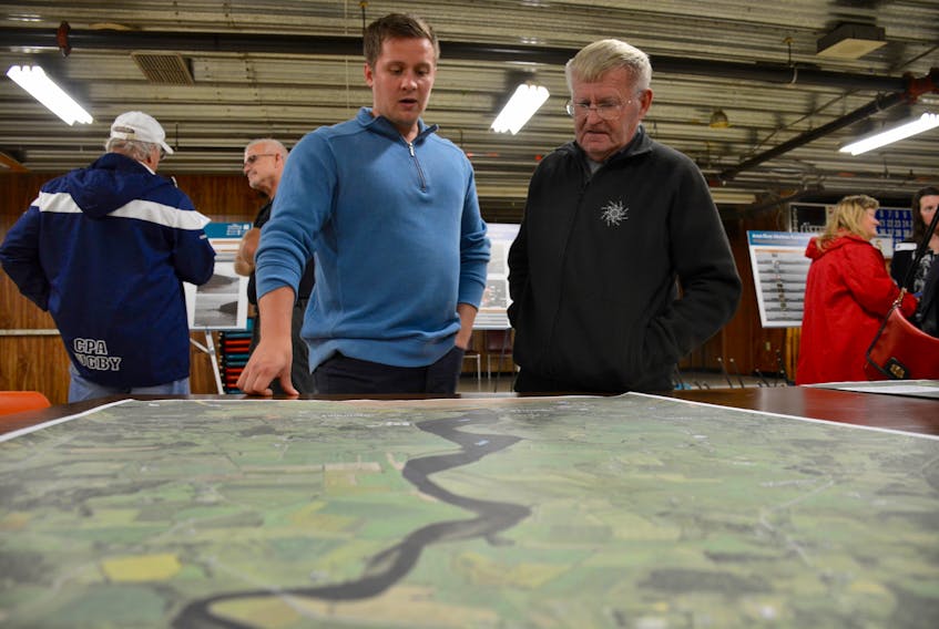 Christopher Ross (left), engineer with the department of agriculture and Windsor resident Dave Carmichael look over some maps of the proposed project.