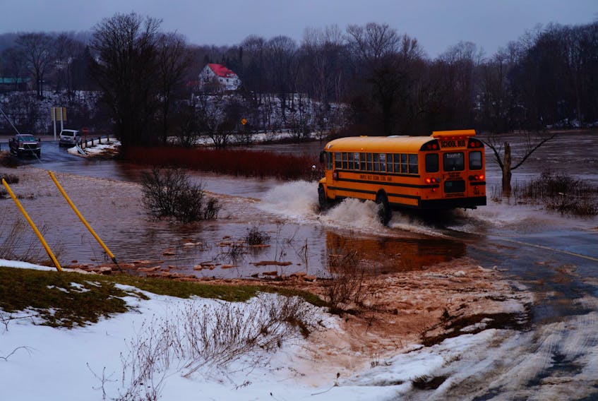 A school bus travels down a flooded Schurman Road on Feb. 2. Due to the condition of the roadway, the end by the Halfway River is now closed to traffic. ALEX HANES