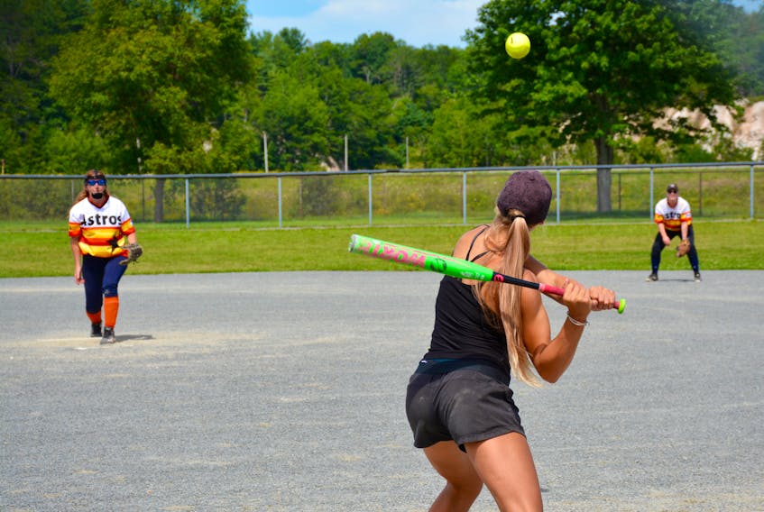 An Avondale Black Bears player swings for the ball during the Windsor Royals Coed Slo-Pitch tournament.