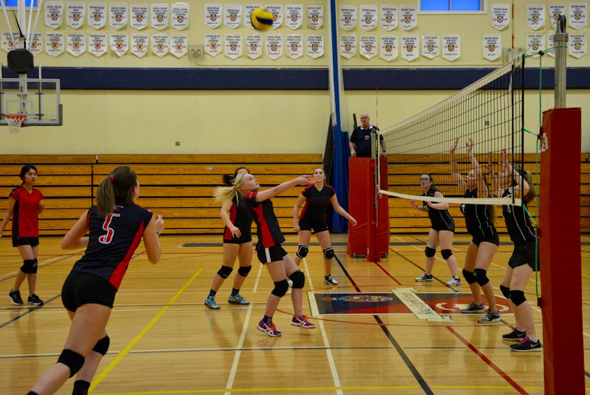 Emma Coughlan, 15, Ella Brown, 16, Elisabeth Lohi, 17, and Maddy Ross, 17 and Hidemi Sato, 16, with the KES varsity girls volleyball team, work together as they take on the Central Kings Rural High School Gators.