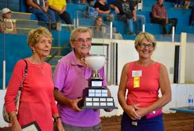 Fran Coombes, left, and Lisa Hines present Ron MacDonald with the first ever David Coombes Exhibition Champion Award in recognition for all of his hard work over the past 60 years.