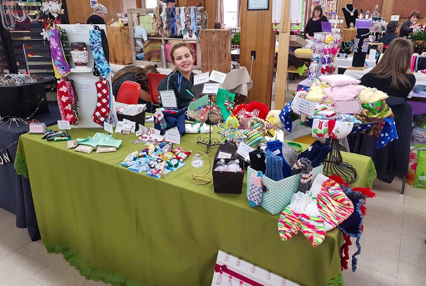 Hannah, 13, with her display of homemade crafts during a craft show in Berwick on Nov. 18. The profits she makes from selling her products goes into her multitude of dance classes and related activities.