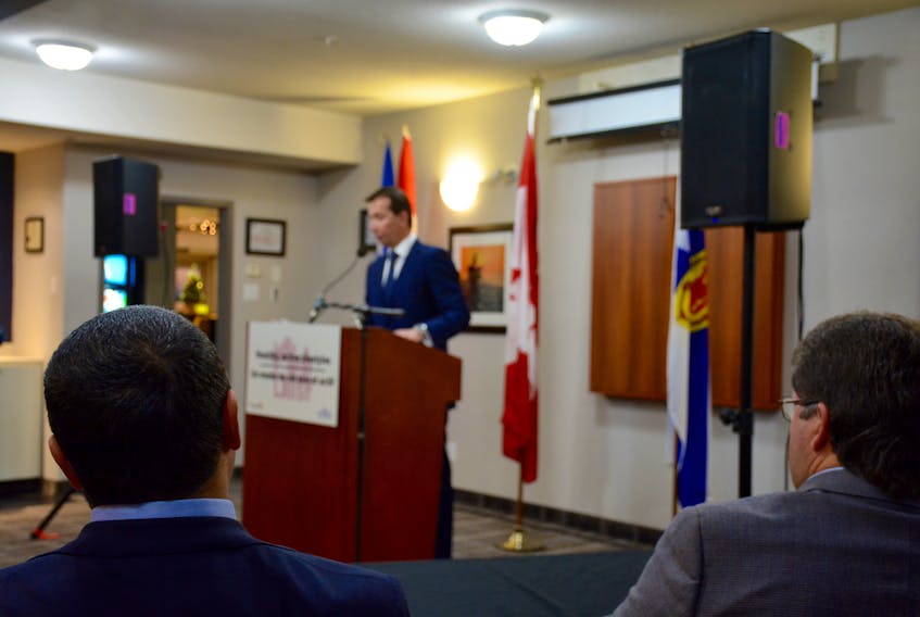 West Hants Warden Abraham Zebian (left) and Hants West MLA Chuck Porter (right) watch as MP Scott Brison makes a joint funding announcement for a new recreation facility in Windsor.