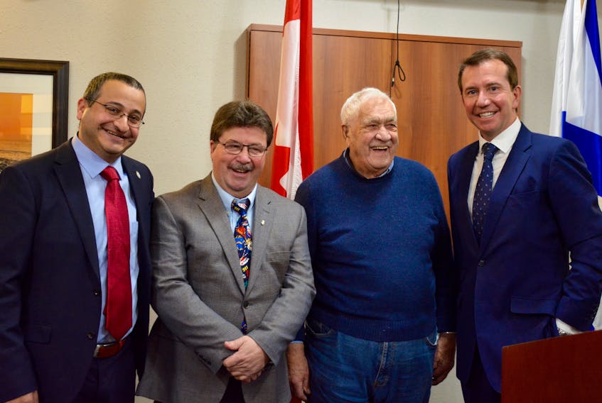 West Hants Warden Abraham Zebian, left, Municipal Affairs Minister Chuck Porter, Windsor hockey player Carl “Chook” Smith and President of the Treasury Board Scott Brison pose for a photo following the announcement.