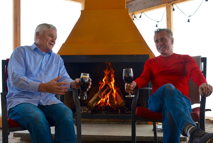 Steven Dodge, left and Glenn Dodge, co-owners of the Bent Ridge winery and Bent Nail Brewery in Windsor Forks, sit inside their newly built solarium, which will allow visitors to stay warm and enjoy the view.