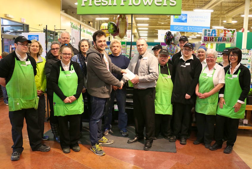 Employees of Sobeys' Windsor location joined with elementary school representatives as store manager Darryl Wilson presented Kyle Dunlop, the music teacher at Brooklyn Elementary School, with cheques for seven elementary school breakfast programs April 14. The store won the 2017 Star of Christmas Sing-Along Contest.