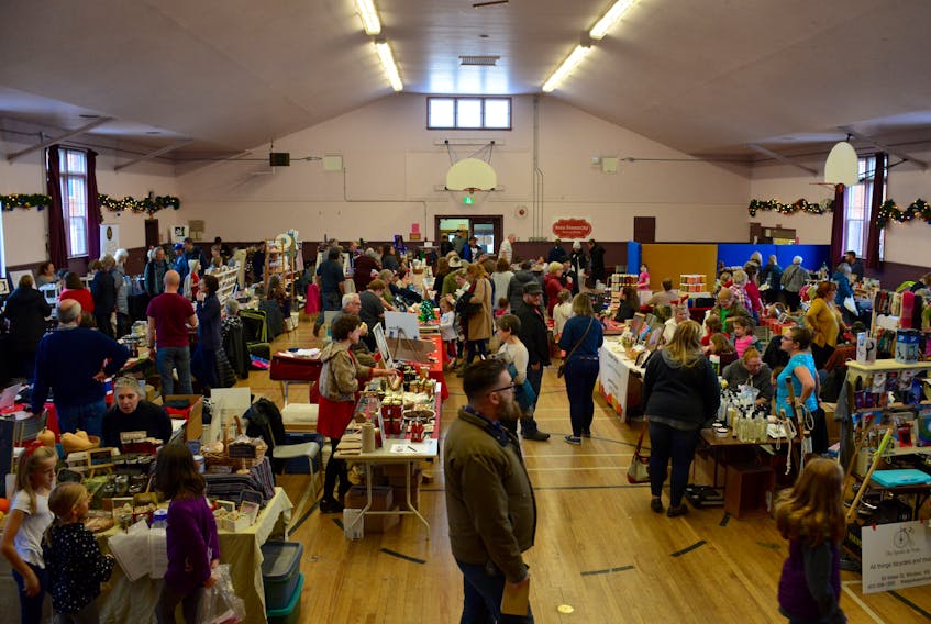 Shoppers and vendors line the Hants County War Memorial Community Centre in Windsor for the first Christmas and Craft Fair hosted by the Avon Community Farmers’ Market.