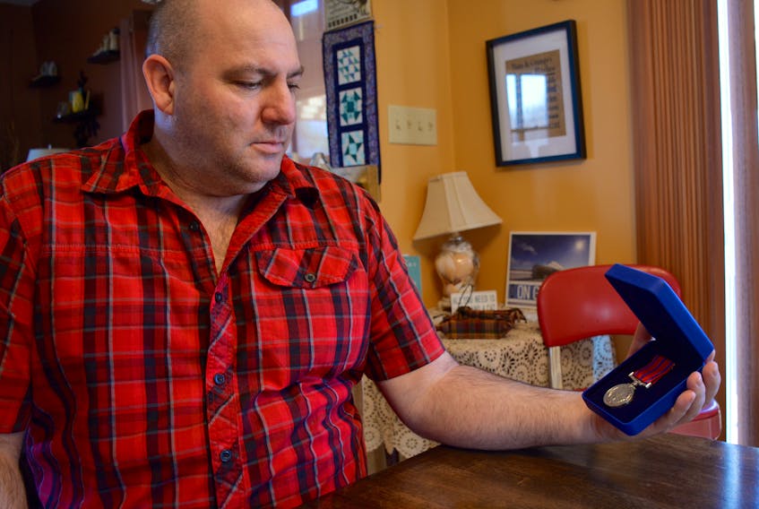 Michael Barkhouse with his medal of bravery in Bramber, Nova Scotia. Barkhouse received the medal after saving a woman’s life from a vicious dog attack in Yellowknife.