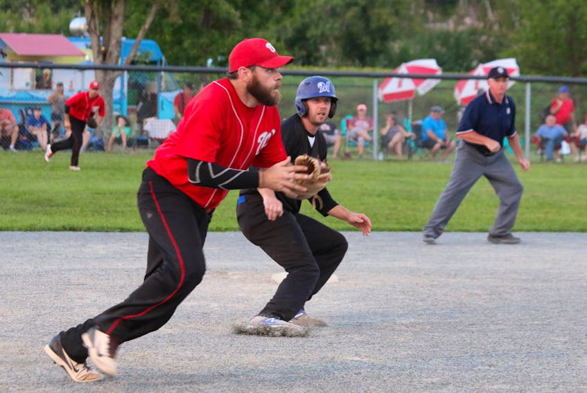Jay Duffy, of the East Hants Mastodons, slams on the breaks as a member of the Wiarton Nationals looks to make the catch and tag him out. - Carole Morris-Underhill