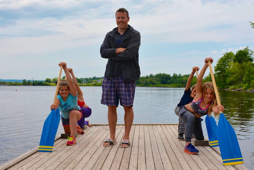 Pisiquid Canoe Club head coach Christian Hall, flanked by club paddlers Kyanna Hope, 11, Sierra Kelly, 11, Maura Macumber, 10 and Ava Woodman, 9 on Lake Pisiquid, has a passion for teaching young athletes.