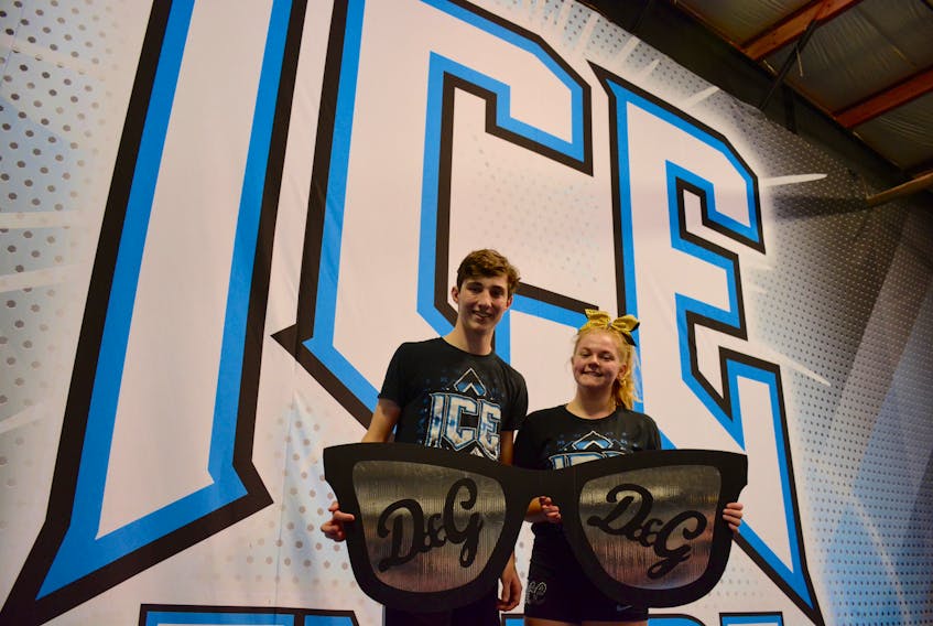 Jaiden Mosher, 13, of Beaver Bank, poses with one of her fellow cheermates Liam Salsman, 15, from Mount Uniacke. They’re holding a large prop that is used within the routine. Both Mosher and Salsman enjoy the camaraderie that ICE provides.