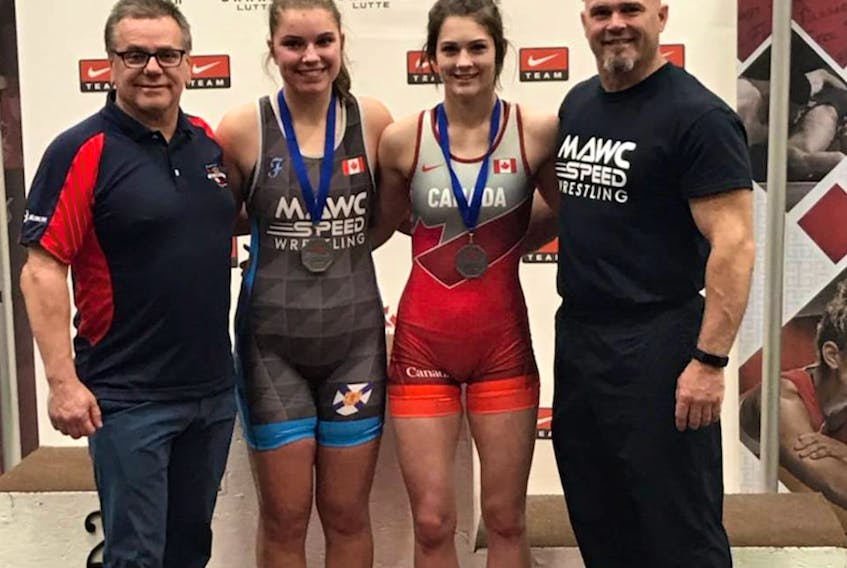 Coach Kim Walsh, Téa Racozzi, Makayla Levy, and coach Gary Levy pose for a photo following a successful showing at nationals.