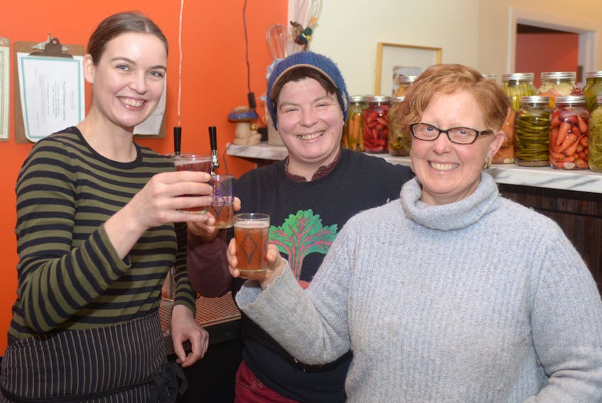 My Plum, My Duck owner Sarah Forrester Wendt, left, celebrates with Heart Beet Organics farm co-owners Verena Varga and Amy Smith over a glass of kombucha Saturday night. The fermented drink is back on tap at the restaurant after it was removed for nearly a week following a now-reversed warning from a P.E.I. liquor inspector.  The organic, farm-brewed drink was served for free on Saturday as a thank you to customers for their support during the ordeal. MITCH MACDONALD/THE GUARDIAN