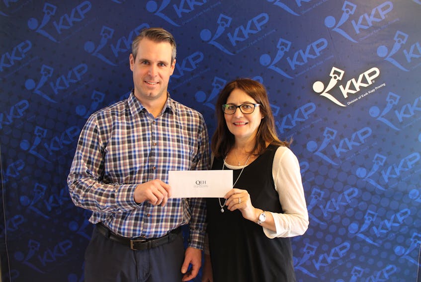 Ben Parsons, co-owner of KKP Print Centre, presents a $2,000 donation to Laura-Lee Lewis, Queen Elizabeth Hospital Foundation Friends for Life cabinet member. This gift will support the purchase of a top 2018-19 campaign priority, a new $1.5 million CT scanner for the QEH, which will perform approximately 11,500 scans annually. Missing from the photo is Ben Howard, co-owner, KKP Print Centre.
