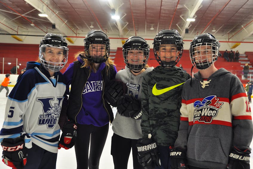 Mackenzie Coade, Maddie Farrell, Nora Kaizer, Kaden Stokvis and Aidan Meister get together and smile at the 2018 Valley Wild Family Fun Holiday Skate at the Centennial Arena in Kentville.