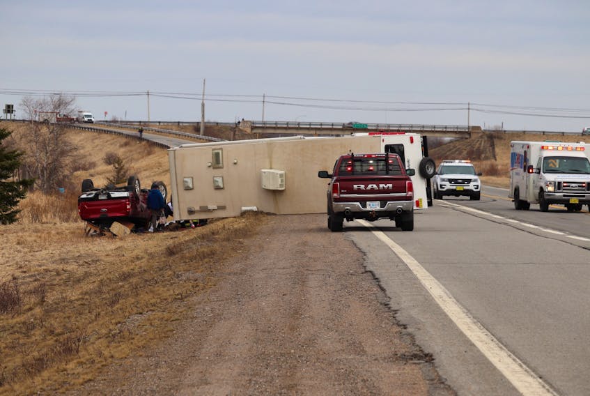 One person was injured when this camper trailed overturned near the Highway 101 ramps in Aylesford April 18. (Adrian Johnstone photo)