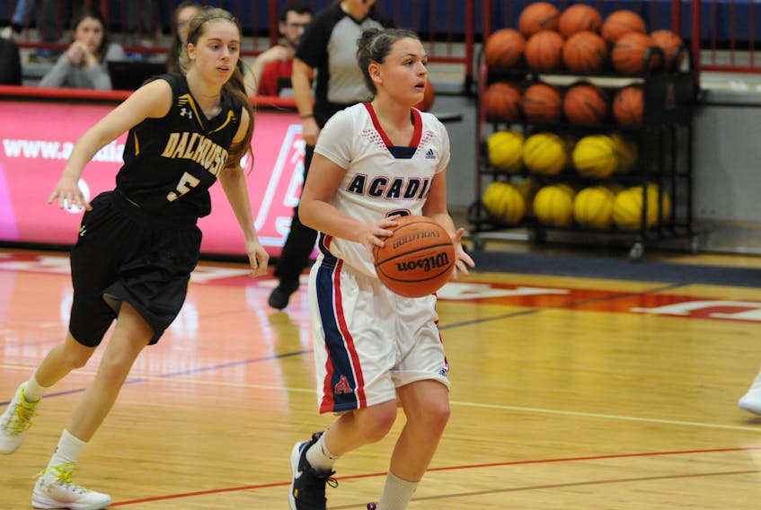 Port Williams native Haley McDonald moves the ball up the court for the Acadia Axewomen.